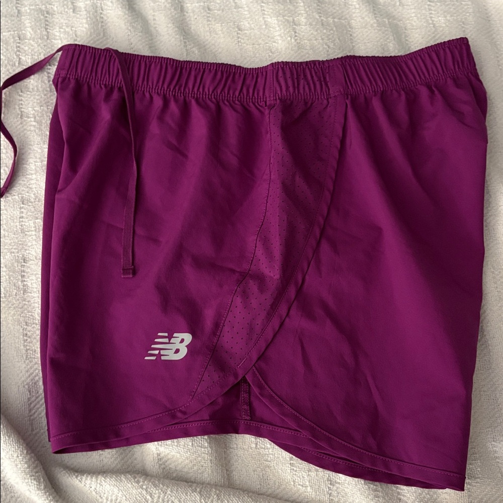 New Balance Women's size M Athletic Shorts in VioletPurple with grey logo.